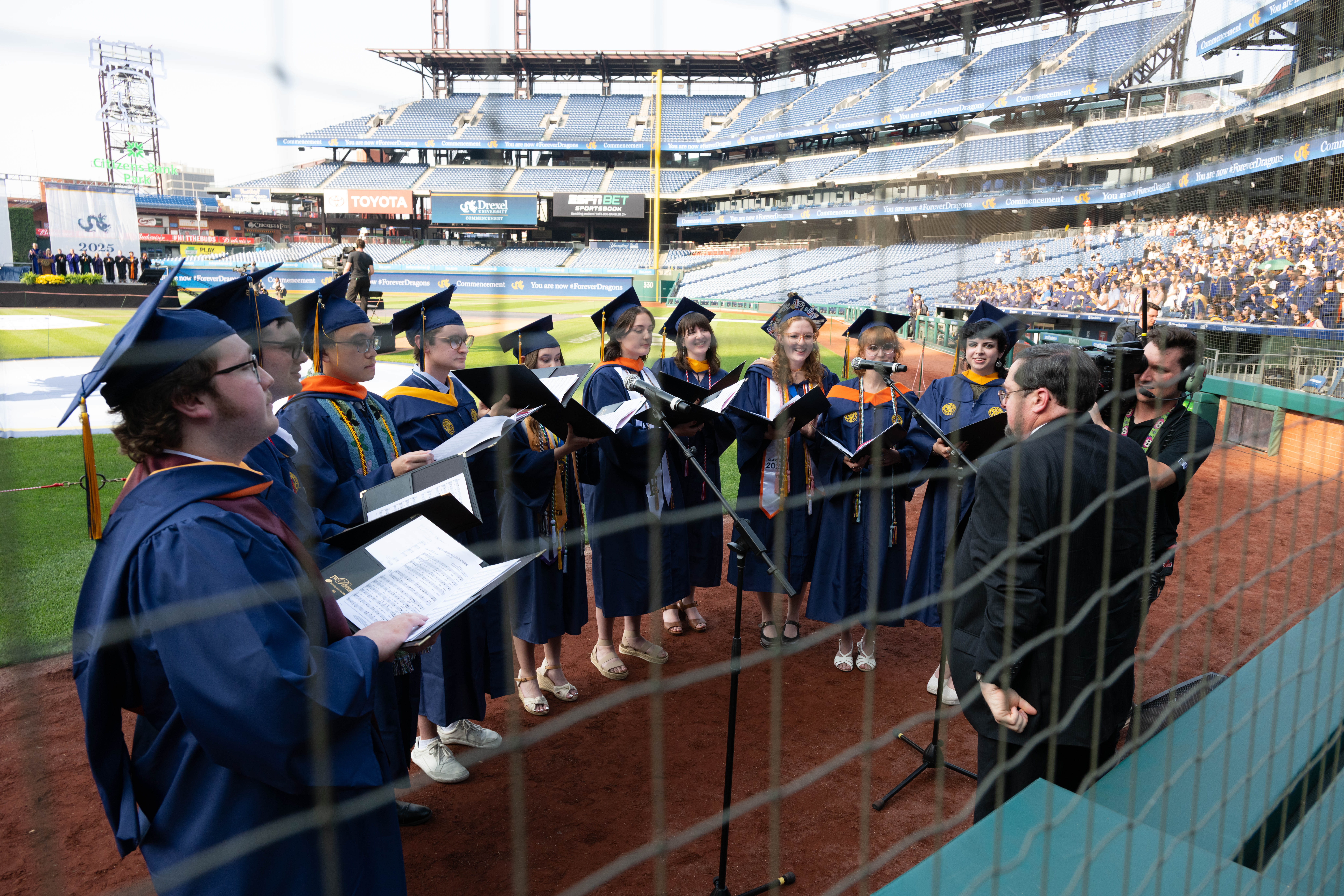 Students singing at home base.