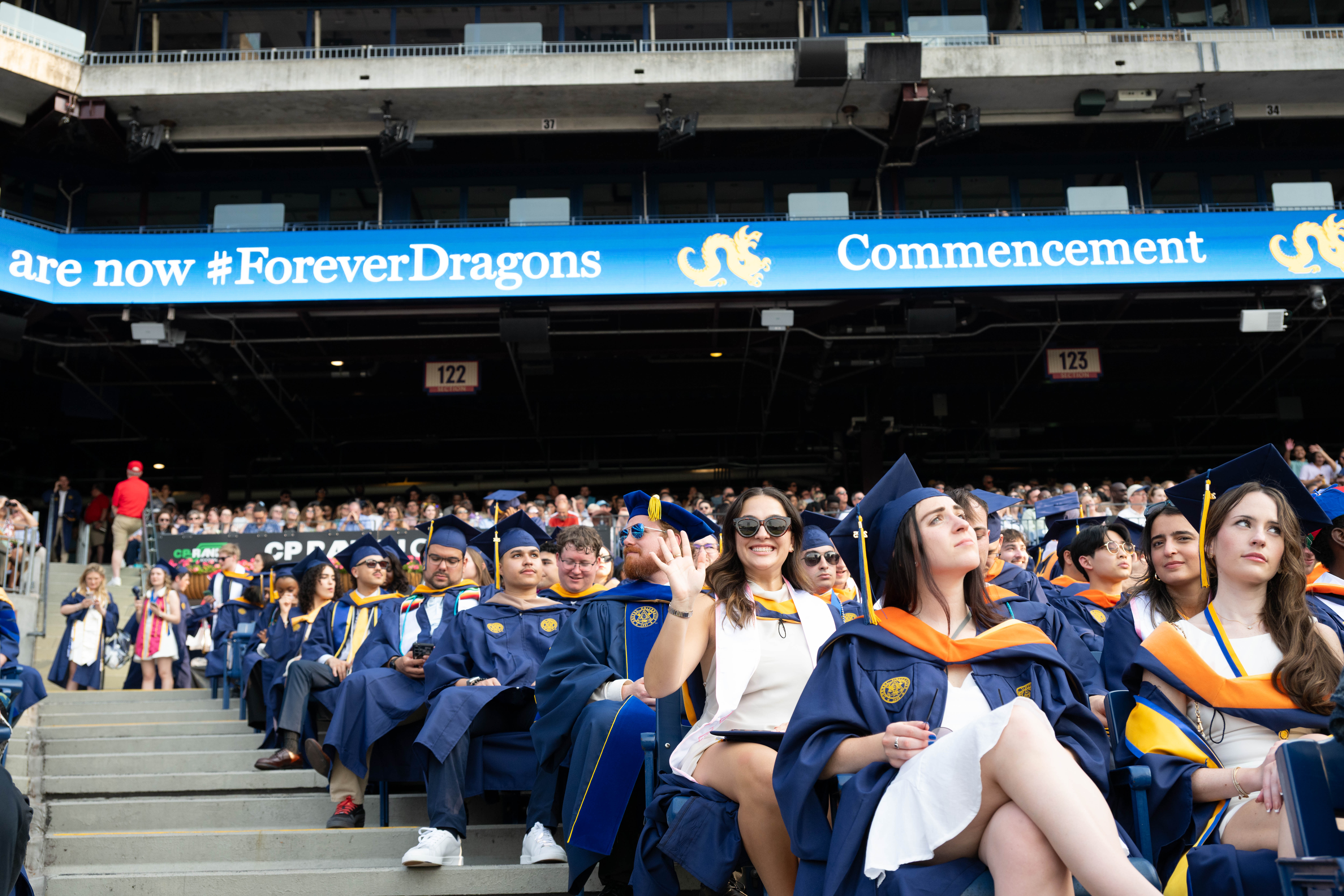 A female student waving in the crowd.