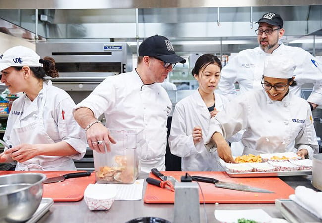 chefs cooking in a kitchen