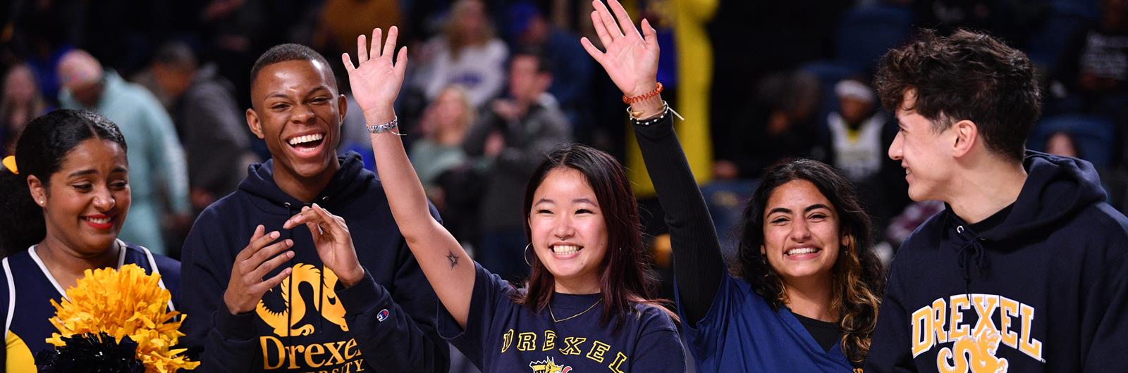 Students waving wearing Drexel gear