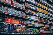 Full shelves with soda, fruit drinks and teas.