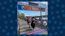 Kaytie Innamorati crosses the finish line in a witch costume