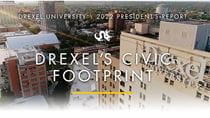 Aerial view of University Crossings building with the text &quot;Drexel University/2022 President&#39;s Report. Drexel&#39;s Civic Footprint.&quot;
