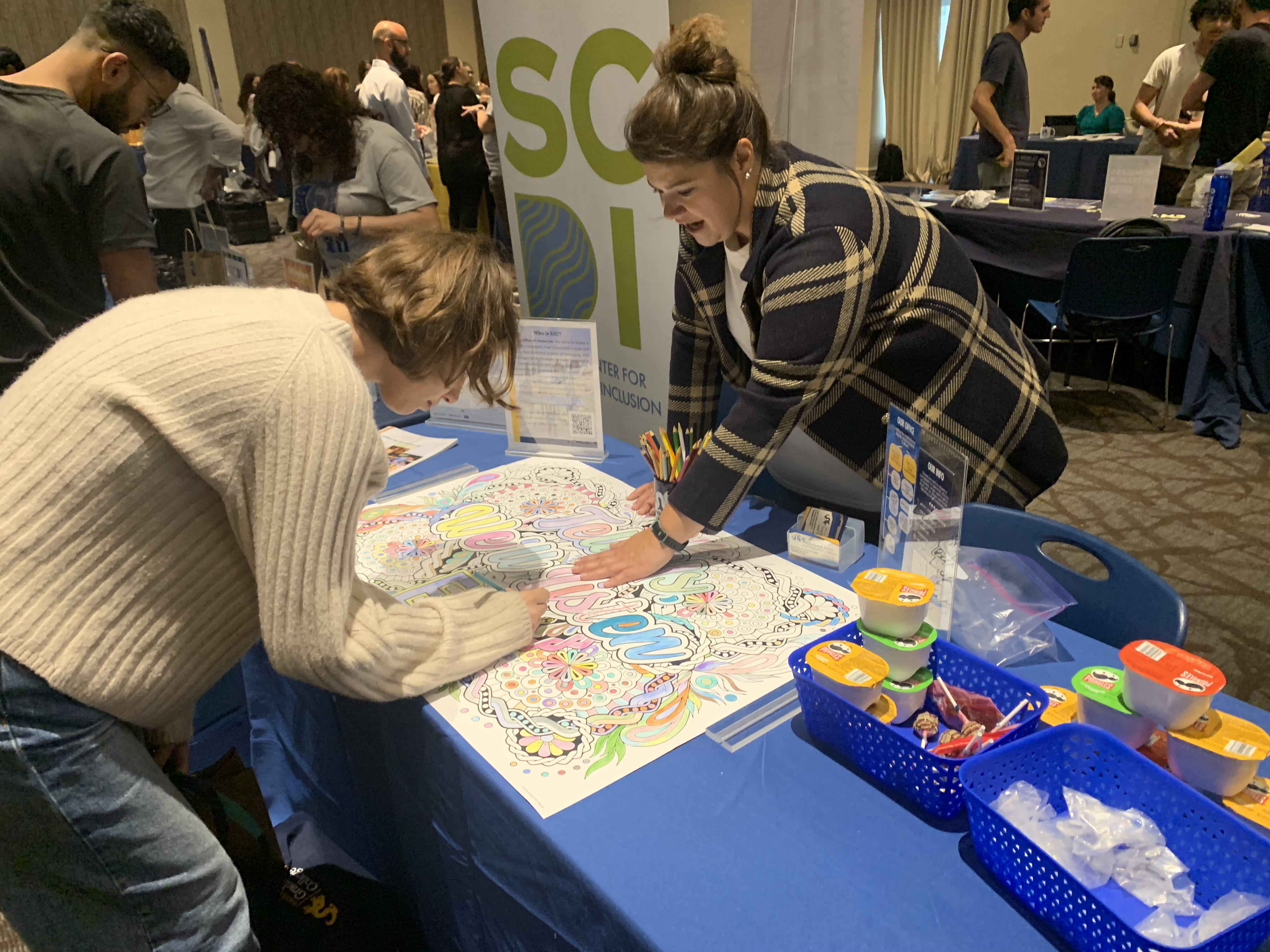 Students color a page with the Office for Institutional Equity at the Resource Fair.