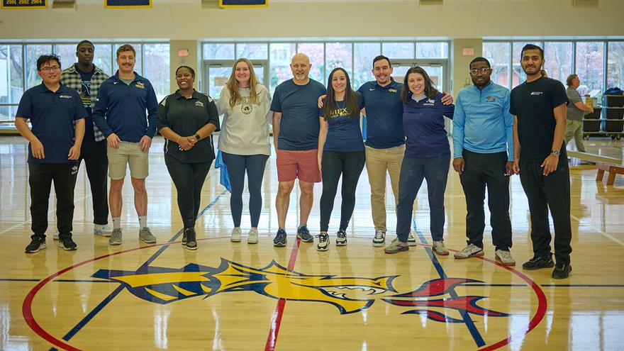 A row of Drexel employees lined up in the basketball court