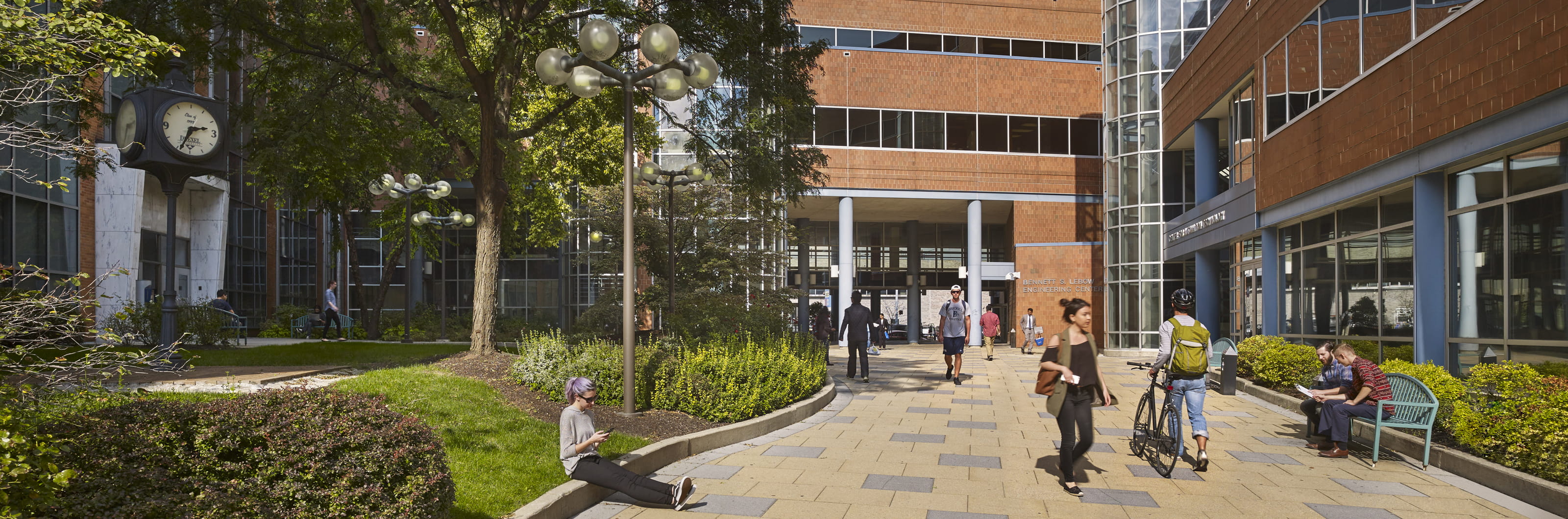 Students relaxing and traveling through a campus walkway