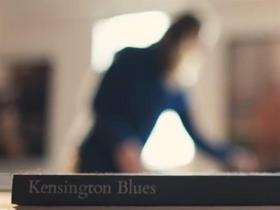 photographer in background, photography book in foreground