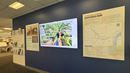 Wall containing posters and a TV screen with "The Philadelphia Challenge"